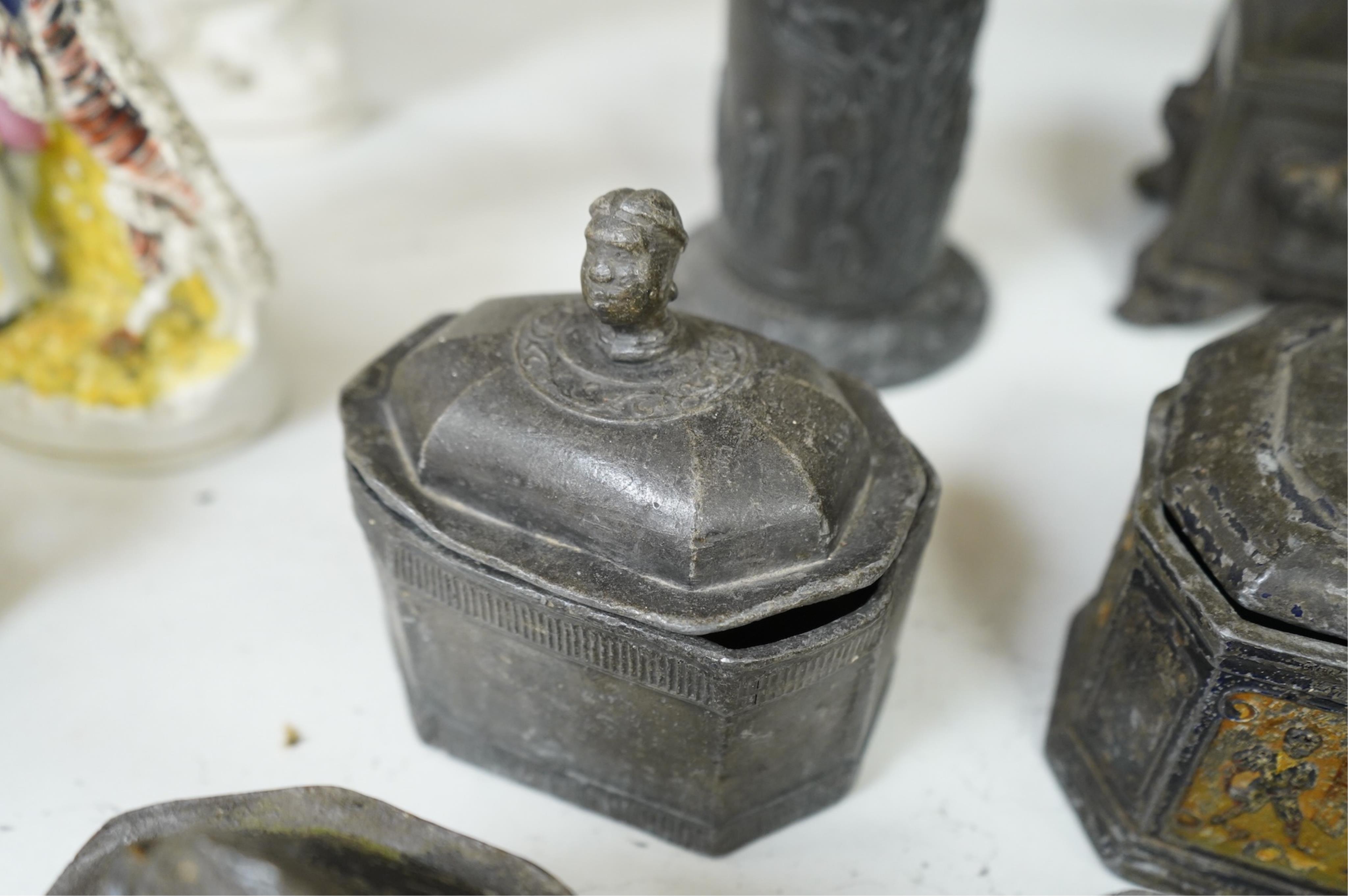 A collection of ten early 19th century lead tobacco boxes to include an octagonal example with remains of paintwork, largest 19cm high
